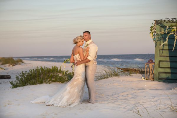 An image of a bride and groom on a beach