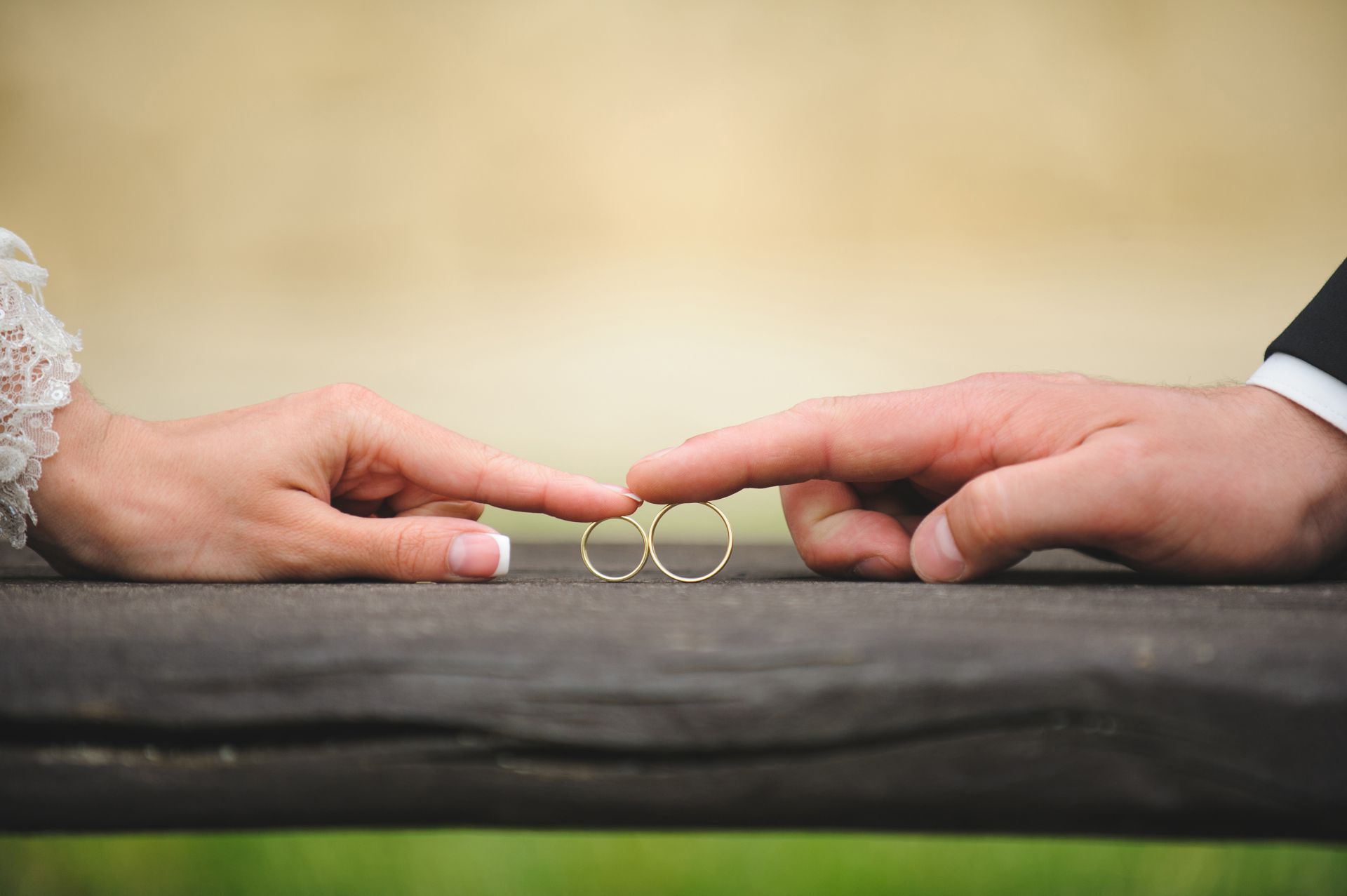 An Image of a bride's hand and groom's hand touching each other