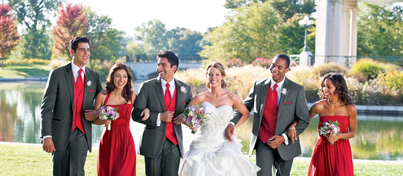 An image of a bride and groom walking with bridesmaids and groomsmen